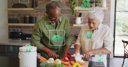 Chopping couple slicing vegetables at home kitchen island, with cutting board and chef's knives. Cooking, culinary, domestic, minimalist, wellness, teamwork, healthyの写真素材