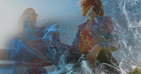 Dancing woman in denim jacket facing man on rooftop with railing, swirling digital water particles. Urban, nightlife, technology, entertainment, lifestyle, vibrant, energeticの写真素材