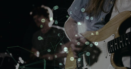 Guitarist strumming electric guitar and drummer hitting drum kit in dim studio with network overlay. Music, band, performance, stage, digital, futuristic, visualの写真素材