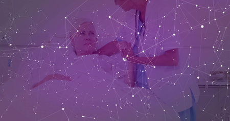 Nurse in blue scrubs injecting into patient arm on hospital bed, with syringe, stethoscope. Clinical, healthcare, medical, sterile, doctor, patient, treatmentの写真素材