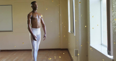 Posing shirtless dancer wearing white tights in studio with windows whiteboard confetti, copy space. Ballet, performance, elegance, artistry, contemporary, minimalism, disciplineの写真素材