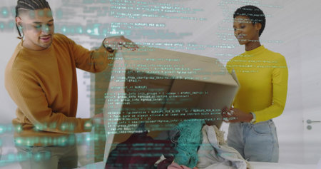 Unpacking orange-sweater and yellow-top couple sorting clothes on bed at home with box. Textiles, garments, cardboard, packaging, pair, apartment, minimalistの写真素材