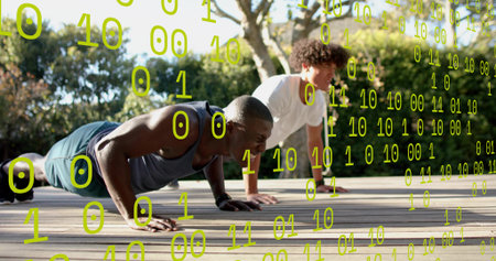 Lowering into push-ups, two men wearing athletic clothes on wooden deck, watch. Fitness, outdoor, workout, training, partnership, strength, daylightの写真素材