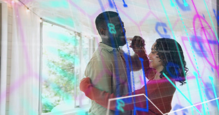 Dancing couple embracing in sunroom with sheer windows, man shirt, woman red sweater, neon overlay. Romance, partners, intimacy, daylight, greenery, glass, warmthの写真素材