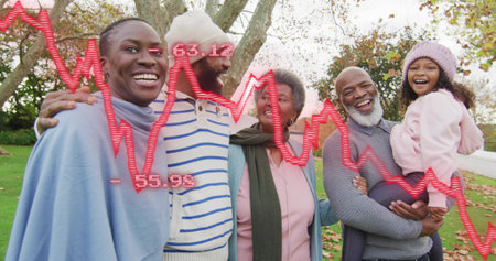 Standing five person family wearing knit hats and coats in park. Multigenerational, togetherness,...