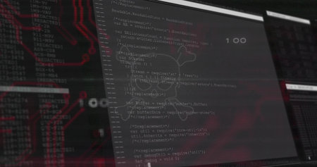 Displaying vertical monitor showing source code with overlay at dark workstation, red PCB....