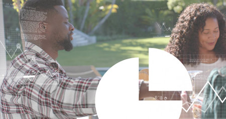 Sitting three adults chatting at backyard table, holding wine glasses, plaid shirt, white overlay. Garden, alfresco, sunny, casual, social, glassware, drinksの写真素材