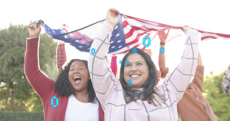 Holding group of friends lifting large American flag above at park, red cardigan pink grid sweater....