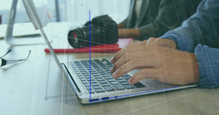 Typing male hands wearing long sleeve blue shirt on light desk, with silver laptop and DSLR. Keyboard, notebook, camera, glasses, grid, desk, officeの写真素材