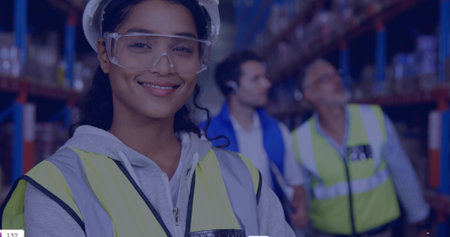 Smiling woman standing left in warehouse aisle, wearing hard hat, safety goggles, vest, copy space....