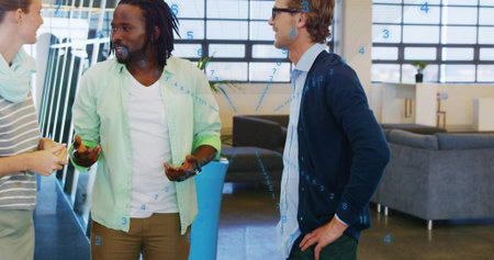 Talking three coworkers wearing green shirt, navy cardigan, holding yellow notepad in office lounge....