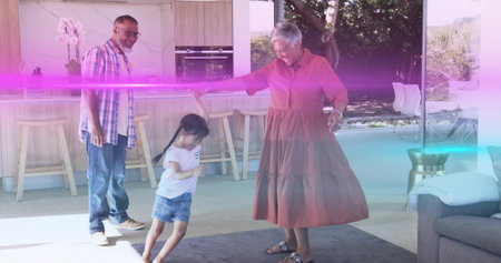 Reaching woman in red dress guiding girl twirling on rug at home, with kitchen island orchid. Family, child, joy, togetherness, bright, openplan, modernの写真素材