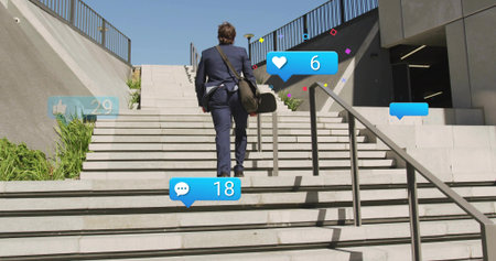 Climbing man in navy suit ascending concrete stairs, carrying shoulder bag with social icons....