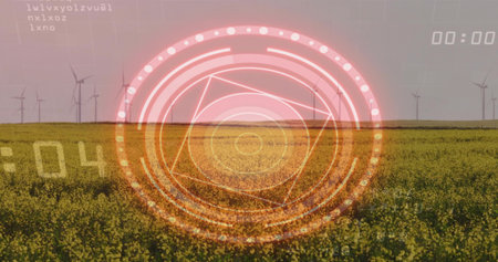 Projecting circular HUD overlaying farmland, showing canola field and wind turbines on horizon. Rural, rapeseed, crop, interface, grid, digital, futuristicの写真素材
