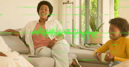 Talking central woman wearing ripped jeans leaning back on sofa, with mug tablet waveform overlay....