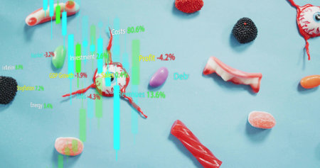 Showing smashed red-white candy oozing syrup on pastel blue table with cyan green charts. Stilllife, confection, multicolor, overlay, studio, surreal, playfulの写真素材