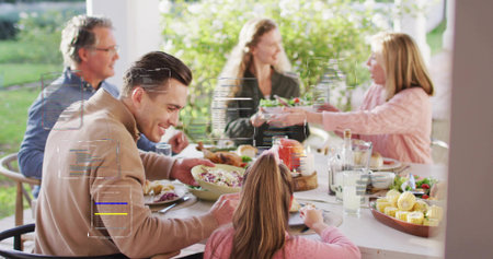 Smiling family group passing salad at covered patio table, man in tan jacket. Multigenerational,...