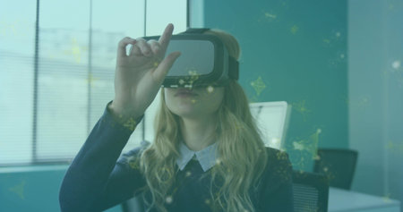 Adjusting woman in collared shirt dark sweater using VR headset at desk, AR overlays. Augmented,...