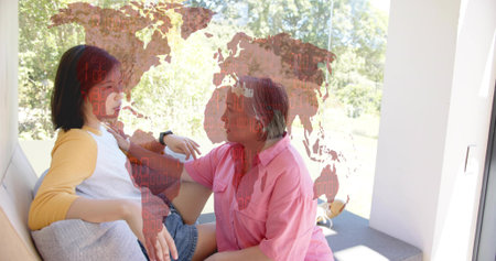Leaning mother in pink shirt supporting reclining woman on home window seat, watch, map overlay....
