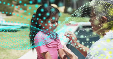 Applying adult wearing cap rubbing sunscreen onto girl in pink shirt at home pool turquoise overlay. Parent, child, backyard, sunlit, outdoor, lotion, lawnの写真素材