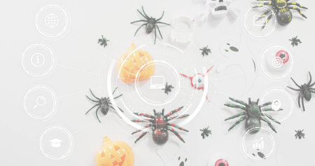 Showing red-accented black toy spider sitting centered on pale table, with Halloween props and HUD. Flatlay, topdown, arachnid, pumpkin, eyeballs, confetti, overlayの写真素材