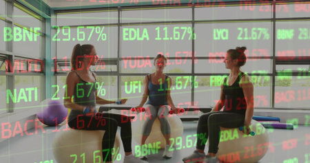 Holding weights, foam-bars, three women in activewear sitting on Swiss balls in gym. Fitness, group,...