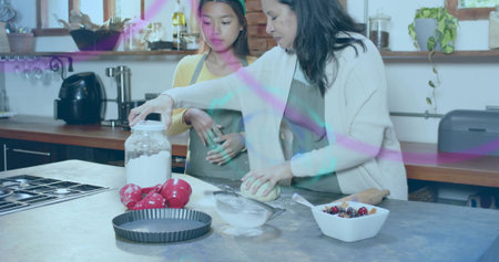 Shaping two women in aprons working dough at home kitchen island, with flour jar, sifter. Baking,...