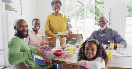 Eating multi-gen family sitting at wooden table at home, wearing yellow sweater. Generational,...