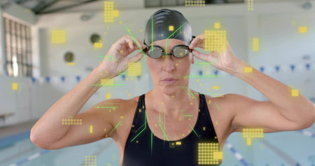 Adjusting female swimmer tightening goggles at pool edge, in black swim cap and swimsuit, with AR. Athlete, focus, training, competition, telemetry, hud, augmentedの写真素材