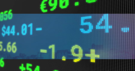 Flashing dot-matrix LED ticker showing large colored digits on city facade, with currency signs. Digital, display, neon, grid, urban, skyline, financeの写真素材