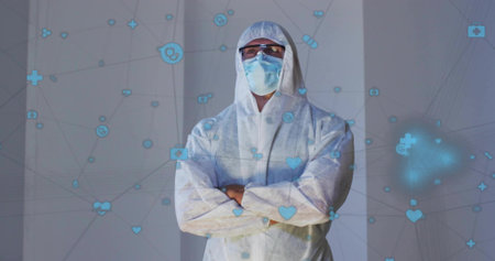 Standing man in hooded coverall at clinical panels, wearing mask, goggles, arms crossed, blue icons. Ppe, healthcare, laboratory, dataviz, network, symbols, safetyの写真素材