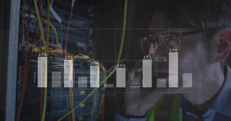 Monitoring tech in hi-vis vest checking racks in server room, patch cables and overlay, copy space. Datacenter, networking, analytics, visualization, wiring, technician, lowlightの写真素材