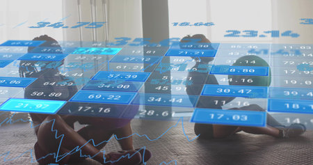 Sitting two women holding legs on mats at fitness studio, wearing sportswear, HUD overlay. Backlit, silhouette, gym, partners, workout, visualization, futuristicの写真素材