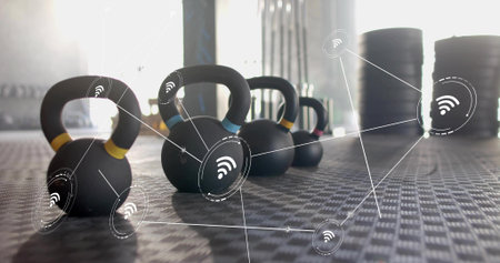 Displaying kettlebells with colored bands sitting on gym flooring. Weights, training, fitness,...