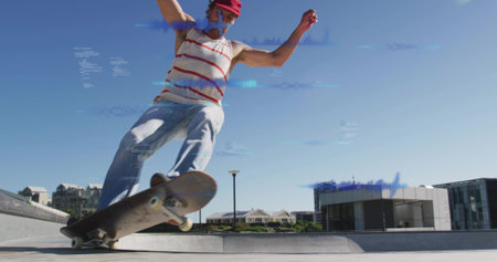 Grinding skater balancing on plaza curb, riding skateboard in striped tank, red cap, blue glitch. Urban, street, trick, motion, daylight, concrete, ledgeの写真素材