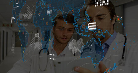 Examining 2 doctors checking tablet in hospital with white lab coats and stethoscopes, digital map. Clinic, collaboration, data, visualization, analytics, corridor, futuristicの写真素材