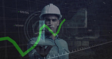Showing engineer wearing white helmet light shirt holding hologram tower at AR lab green graph HUD. Construction, engineering, augmentedreality, data, visualization, grid, buildingの写真素材