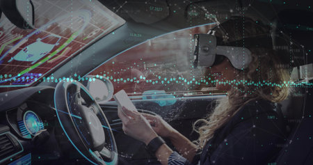 Testing AR, mid-adult woman wearing VR headset and dark blazer holding smartphone near HUD....