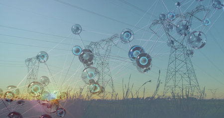 Framing high-voltage towers with power lines showing glowing blue nodes in grassy field at sunset....