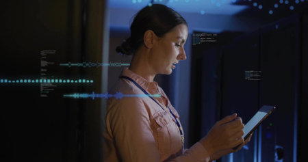 Tapping tablet technician monitoring racks in data center, wearing pink shirt, lanyard ID, overlays....