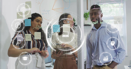 Adjusting three-person team in business wear, moving post-its and drawing on glass wall, HUD icons....