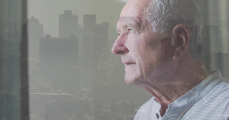 Gazing man looking out window at skyline overlay and drape, wearing striped shirt, copy space. Elderly, cityscape, doubleexposure, interior, urban, portrait, mutedの写真素材