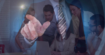 Pointing foreground hand guiding team at office table, with laptop mug suit-and-tie overlay. Gesture, collaboration, meeting, conference, professionals, business, strategyの写真素材