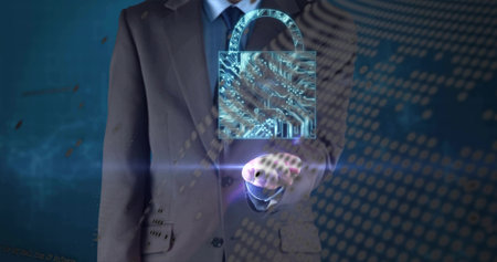 Mid-adult man in dark suit projecting holographic padlock above palm in blue studio with matrix. Security, cyber, encryption, data, protection, corporate, executiveの写真素材