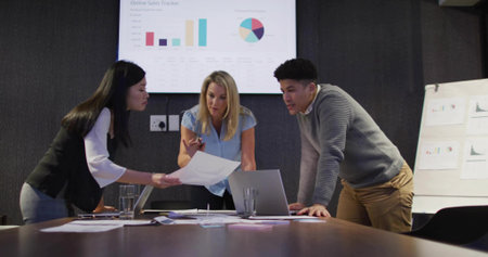 Tech user tapping tablet screen visualizing data through glowing schematics floating TECH lettersの写真素材