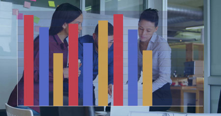 Collaborating three coworkers in business shirts reviewing laptop in office, with bar chart overlay. Teamwork, colleagues, boardroom, openplan, graph, modern, notesの写真素材