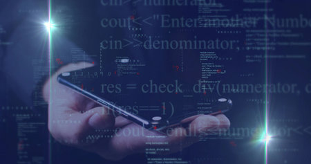 Holding smartphone with mid adult male's hand in dark studio, showing code overlays, lens flares. Device, interface, blue, neon, futuristic, holographic, digitalの写真素材