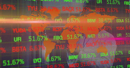 Analyzing man in business suit studying market data in trading office with tickers, copy space....