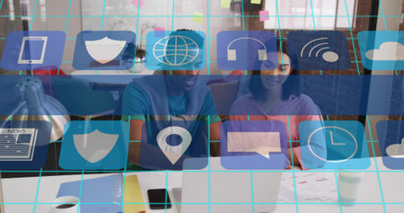 Collaborating two colleagues in casual workwear typing on laptop at office desk, overlay. Coworking, teamwork, modern, vibrant, openplan, workspace, gridの写真素材