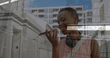 Speaking woman with headset and pink top holding smartphone on sidewalk, encryption UI, copy space. Urban, street, code, binary, waveform, overlay, securityの写真素材
